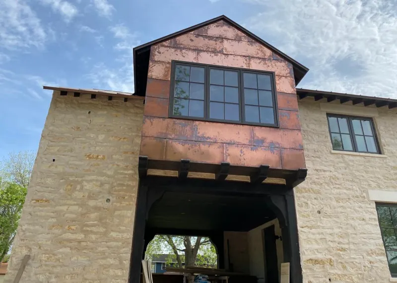 Copper metal panel facade on a stone building for Skylight Installation in Horseheads